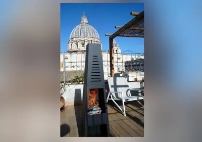a fireplace on the roof of a building with a dome at La CasUPOLA Saint Peter's Quiet Room in Rome