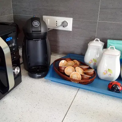 a coffee maker and a tray of pastries on a counter at La CasUPOLA Saint Peter's Quiet Room in Rome