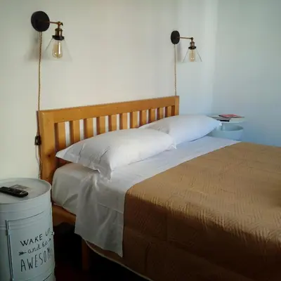 a bedroom with a bed and a trash can at La CasUPOLA Saint Peter's Quiet Room in Rome