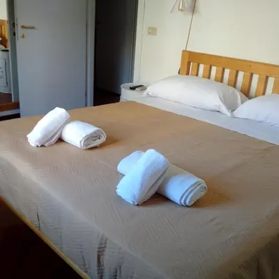 two white towels sitting on top of a bed at La CasUPOLA Saint Peter's Quiet Room in Rome