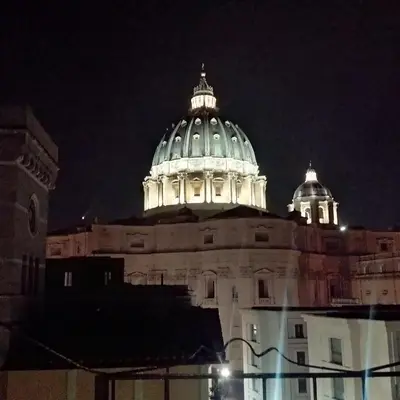 a large building with a domed roof at night at La CasUPOLA Saint Peter's Quiet Room in Rome