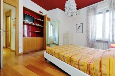 a bedroom with a bed and a television in it at Angelico Family Apartment in Rome