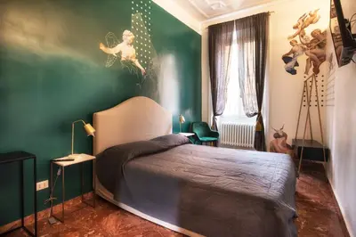 a bedroom with a bed and a green wall at San Pietro Suite Rome in Rome
