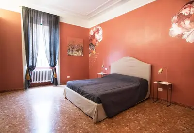 a bedroom with orange walls and a bed in it at San Pietro Suite Rome in Rome