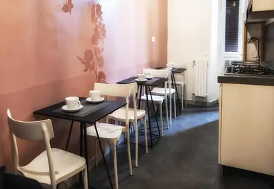 a row of tables and chairs in a restaurant at San Pietro Suite Rome in Rome