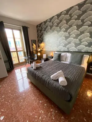 a bedroom with a large bed with two towels on it at Cavour Urban Rooms by GHOR in Rome