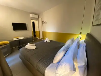 a bedroom with a bed with pillows on it at Cavour Urban Rooms by GHOR in Rome