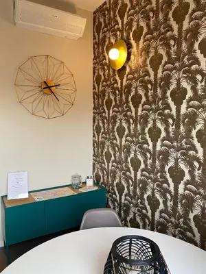 a meeting room with a wall with a wallpaper at Cavour Urban Rooms by GHOR in Rome
