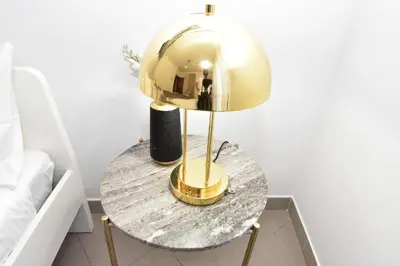 a table with a gold lamp on top of it at Diasof Apartments in Rome