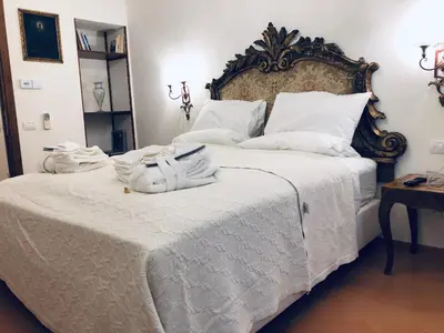a bedroom with a large white bed with towels on it at Visione Via Sant’Andrea delle Fratte, 36 in Rome