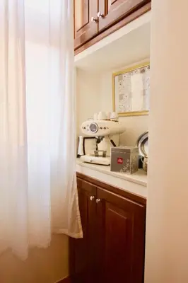 a kitchen with a white curtain next to a window at Visione Via Sant’Andrea delle Fratte, 36 in Rome