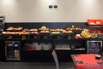 a display case with a bunch of food on at Floris Hotel in Rome