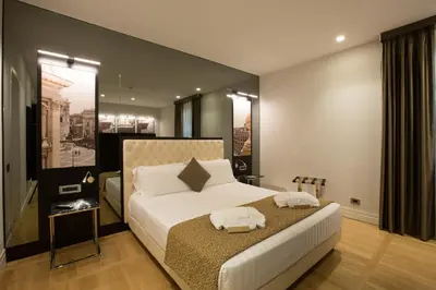 a bedroom with a bed with two towels on it at Floris Hotel in Rome