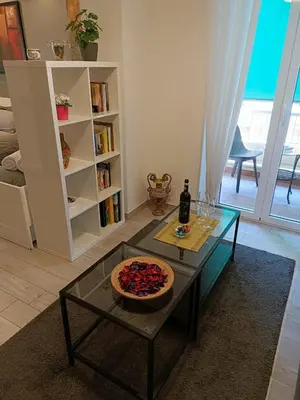 a living room with a table and a bottle of wine at Vatican Break Home in Rome