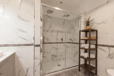 a shower with a glass door in a bathroom at Vatican Break Home in Rome