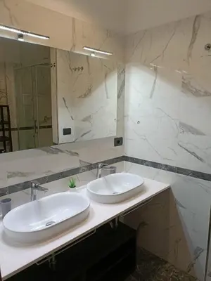a bathroom with two sinks and a large mirror at Vatican Break Home in Rome