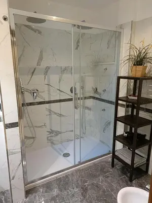 a shower with a glass door in a bathroom at Vatican Break Home in Rome