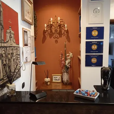 a room with a counter with a chandelier and a table at Vatican Break Home in Rome