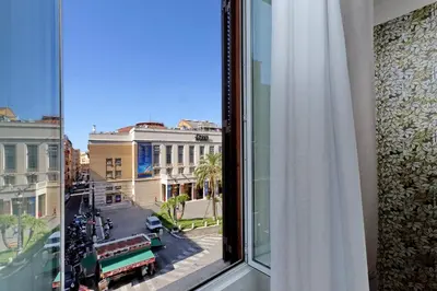 a window with a view of a city street at Opera 58 - Teatro dell'Opera Suites in Rome