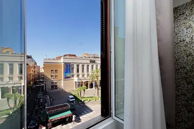 a window with a view of a city street at Opera 58 - Teatro dell'Opera Suites in Rome