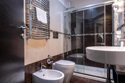 a bathroom with a toilet and a sink and a shower at Mia Resort in Rome