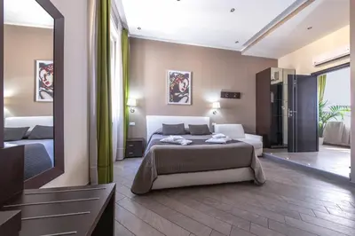 a bedroom with a bed and a large mirror at Mia Resort in Rome