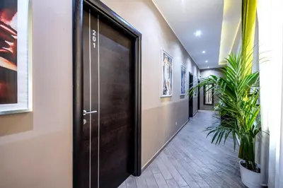 a hallway with a wooden door and plants at Mia Resort in Rome