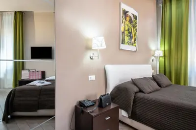 a hotel room with two beds and a television at Mia Resort in Rome