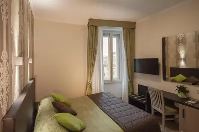 a bedroom with a bed and a desk and a window at Mia Resort in Rome