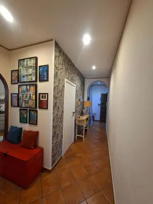 a hallway of a home with a couch and a table at Athena's Apartment in Rome