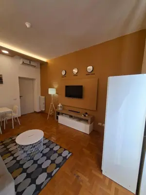 a living room with a flat screen tv on a wall at Athena's Apartment in Rome