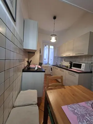 a kitchen with a table and a dining room at Athena's Apartment in Rome