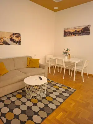 a living room with a couch and a table at Athena's Apartment in Rome