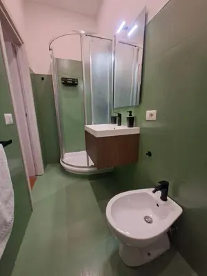 a bathroom with a sink and a shower and a toilet at Athena's Apartment in Rome