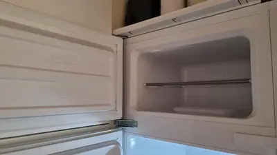 an empty refrigerator with its door open in a kitchen at Studio della Pace, Classy & Charming - RENOVATED in Rome