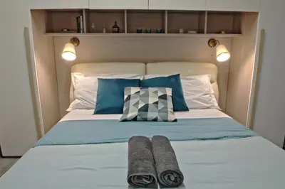 a bedroom with a bed with two towels on it at La Maison In Rome in Rome