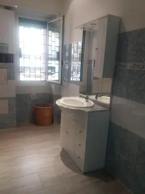 a bathroom with a sink and a mirror at La Maison In Rome in Rome