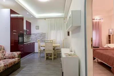 a living room with a kitchen and a dining room at La Maison In Rome in Rome