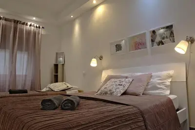 a bedroom with a large bed with two pillows on it at La Maison In Rome in Rome