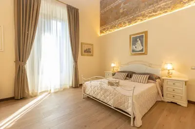a bedroom with a bed and a large window at Kings Home In Rome in Rome