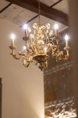 a large gold chandelier hanging from a ceiling at Kings Home In Rome in Rome