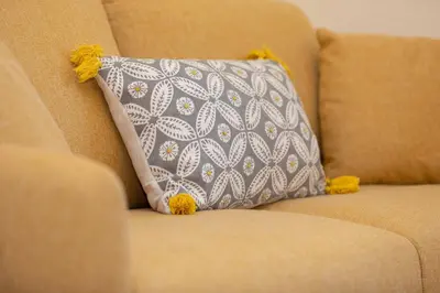 a pillow on a chair with yellow pompoms at Kings Home In Rome in Rome