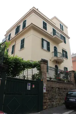 a large white house with a black gate at Casa per Ferie Beato Rosaz in Rome