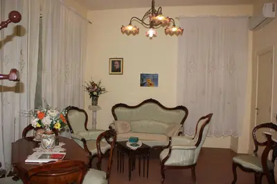 a living room with a table and chairs at Casa per Ferie Beato Rosaz in Rome