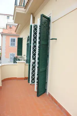 a pair of green doors on the side of a building at Casa per Ferie Beato Rosaz in Rome