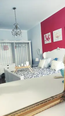 a bedroom with a bed with a mirror on it at Garbatella Chippendale Apartment in Rome