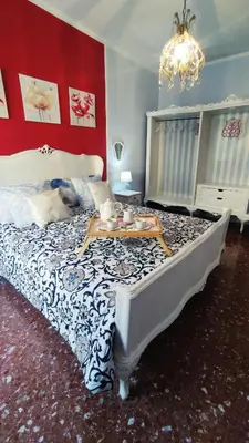 a bedroom with a bed with a blue and white comforter at Garbatella Chippendale Apartment in Rome