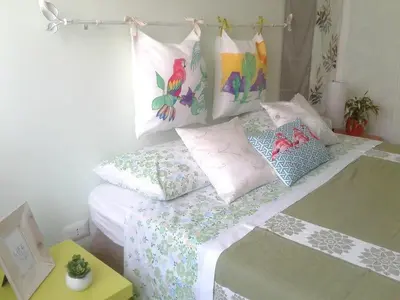 a bedroom with a bed with pillows on it at Garbatella Chippendale Apartment in Rome