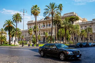 a black car parked in front of a building at The Shell Rome Suite in Rome
