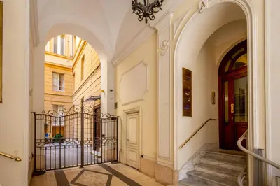 a hallway with a door and stairs in a building at The Shell Rome Suite in Rome
